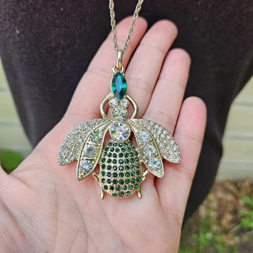 gold tone clear and green rhinestone bug pendant necklace
